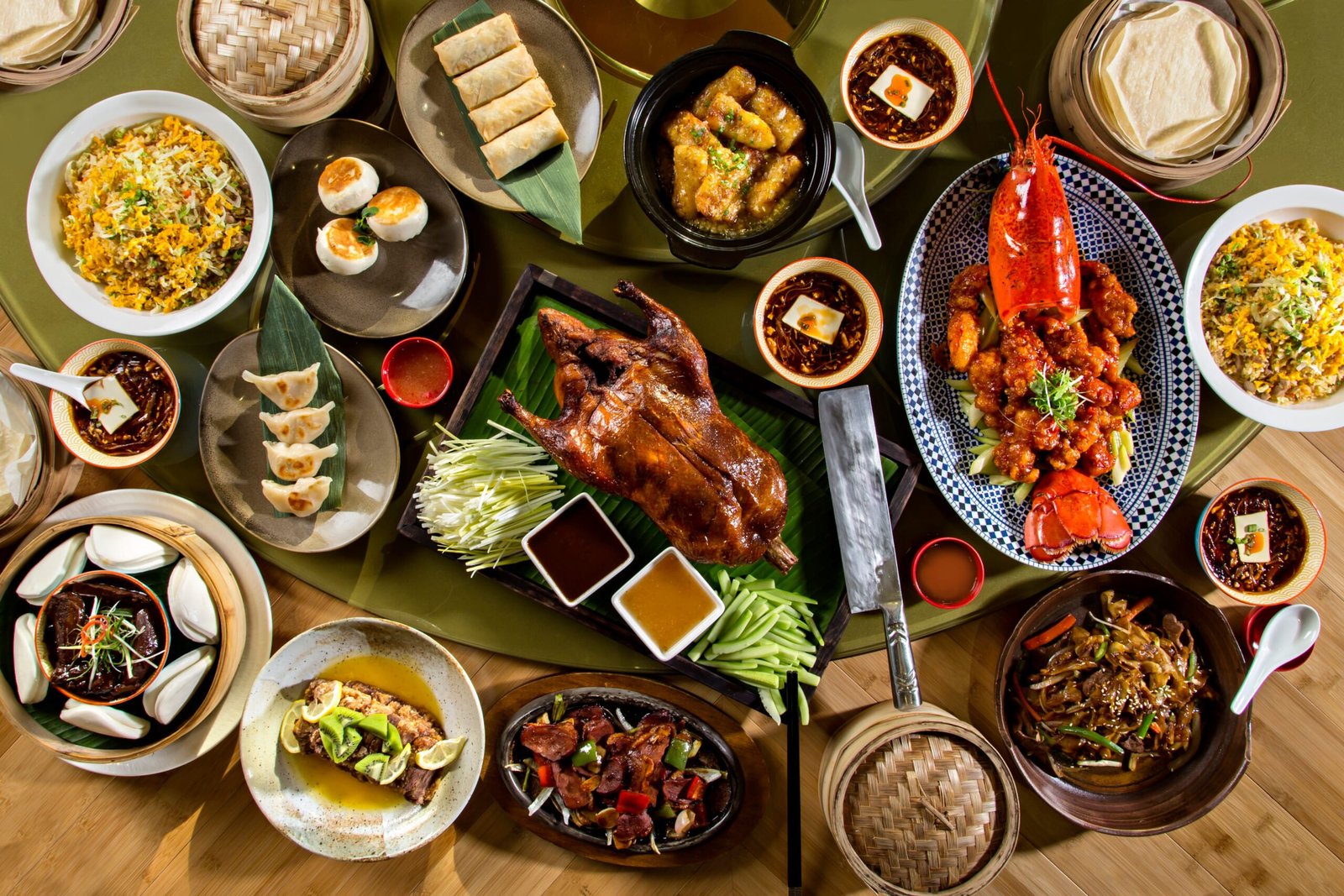 An abundant Chinese banquet with roast duck, lobster, dumplings and colorful shared dishes
